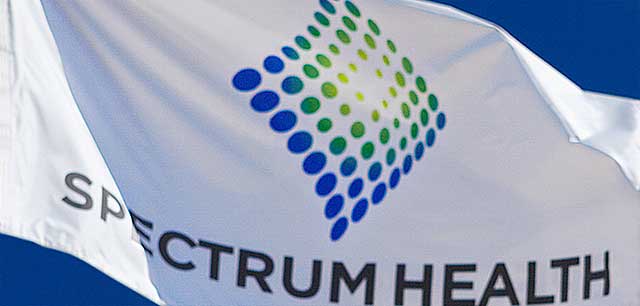 Spectrum Health System logo close-up on a flag